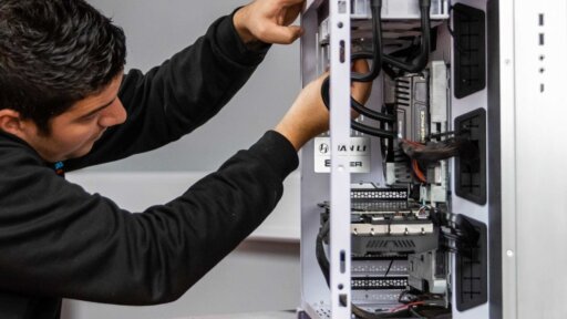 Photograph showing a man building a PC