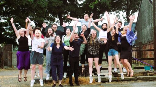 Photograph showing students from Revolution Performing Arts jumping in the air and smiling.