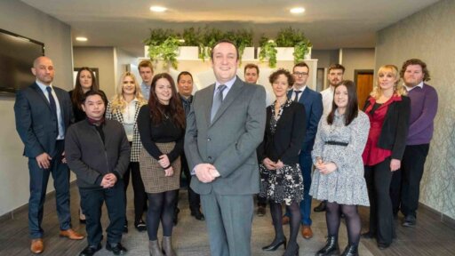 A photo of a group of staff members in a room