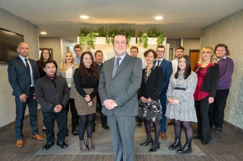 A photo of a group of staff members in a room