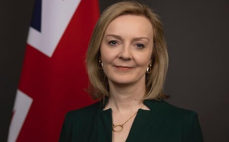 A photograph of Liz Truss, Prime Minister, next to the Union Flag