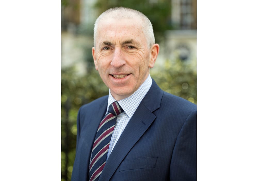 A head and shouldrrs photo of Neil Stewart, chairman of R3’s Southern and Thames Valley region, wearing a suit and tie