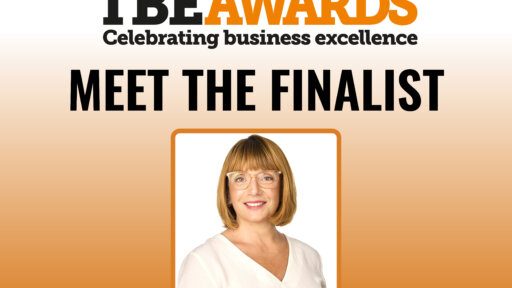 Promotional graphic for the TBE Awards featuring the headline “Meet the Finalist” and a framed photograph of Catherine Smith. She has shoulder-length hair, wears glasses and a white top. The background fades from white to orange, with the TBE Awards tagline “Celebrating business excellence” at the top.