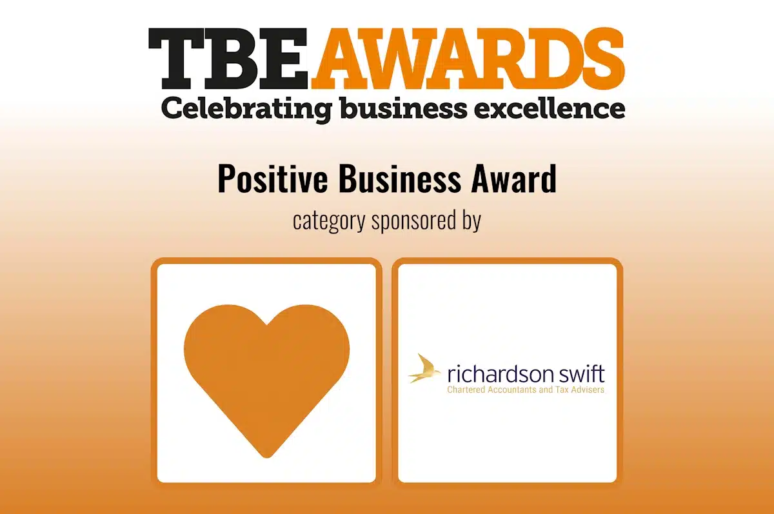 Graphic for the TBE Awards with the headline “Positive Business Award.” The top section reads “TBE Awards – Celebrating business excellence” in black and orange text. Below, it says “Positive Business Award – category sponsored by” followed by the Richardson Swift logo, which includes a gold bird icon and the text “Richardson Swift Chartered Accountants and Tax Advisers.” On the left is an orange heart icon inside a square frame.