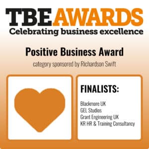 Graphic for the TBE Awards with the headline “Positive Business Award.” The top section reads “TBE Awards – Celebrating business excellence” in black and orange text. Below, it says “Positive Business Award – category sponsored by Richardson Swift.” On the left is an orange heart icon inside a square frame. On the right is a white box with the heading “FINALISTS:” in bold black text, listing:
Blackmore UK
GEL Studios
Grant Engineering UK
KR HR & Training Consultancy.