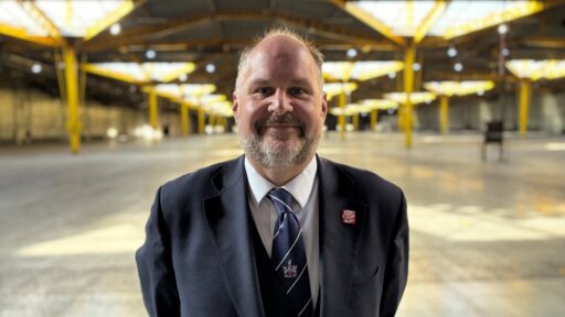 Councillor Jim Robbins, Leader of Swindon Borough Council, standing indoors wearing a dark suit, light shirt, and patterned tie, facing the camera against a plain background.