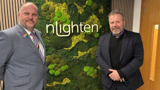Photo of Jim Robbins and Jim Robbins (left) with Justin Nesbitt, Managing Director of nLighten UK standing in front of the company logo
