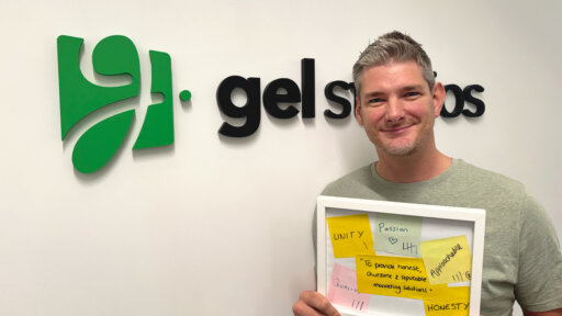 Graeme Leighfield smiling wearing a grey tshirt with the gel studios logo in the background