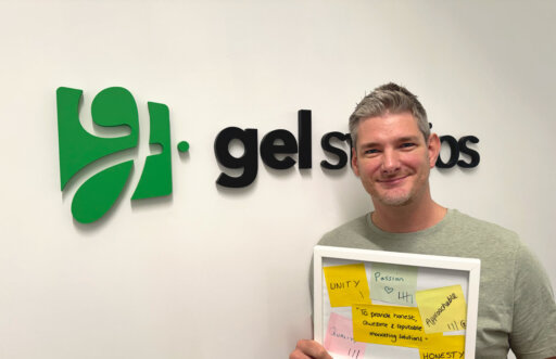 Graeme Leighfield smiling wearing a grey tshirt with the gel studios logo in the background