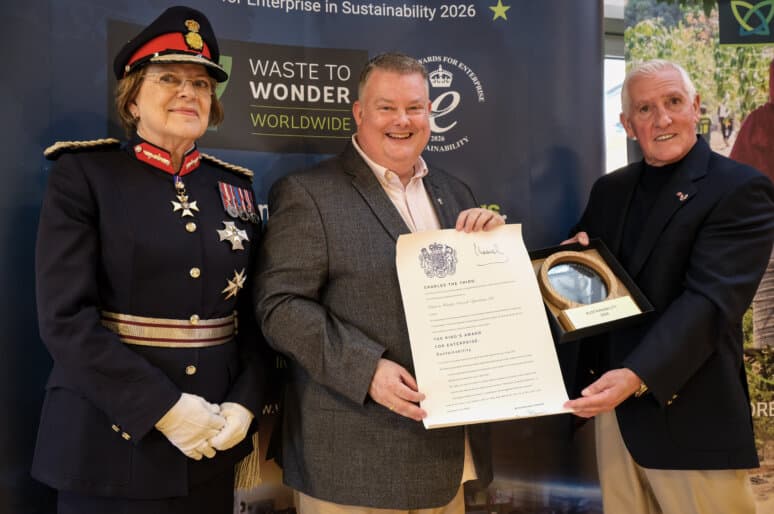: His Majesty’s Lord-Lieutenant of Wiltshire, Dame Sarah Troughton presents The King’s Award for Enterprise in Sustainability 2026 to Waste to Wonder Worldwide Managing Director Michael Amos and Co-Founder Alan Cooper OBE at Fairfield College in Dilton Marsh]