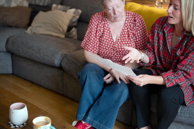 iCare4 founder talking to patient on sofa